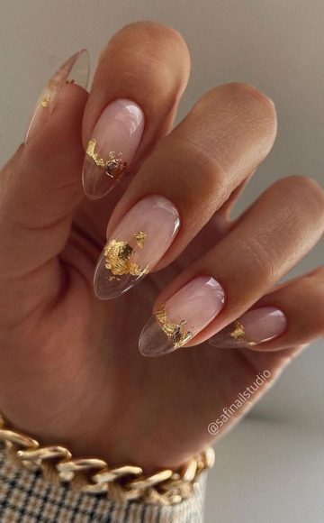 Pretty long almond-shaped clear nails with gold flakes | Transparent nails