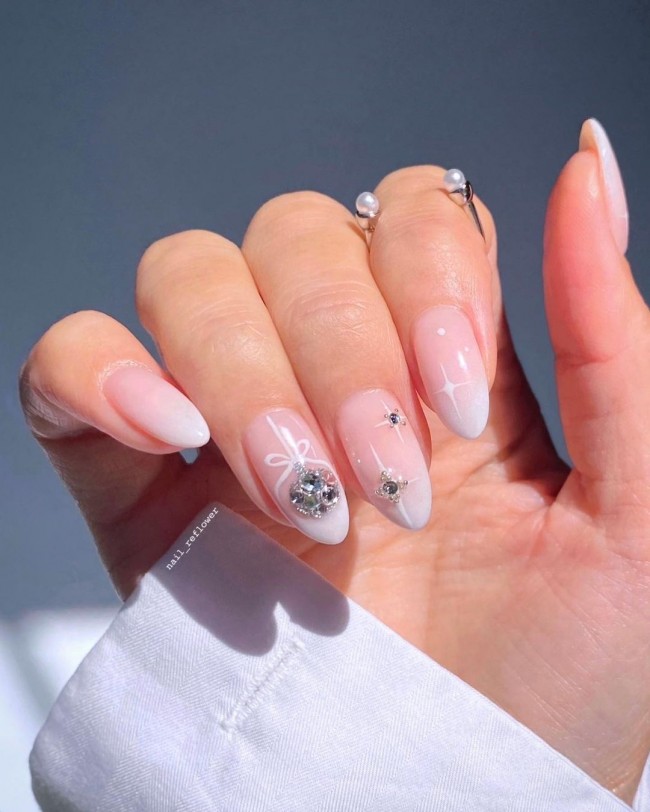 30 White Christmas Nails That Are So Trendy — White Milky Ombre Christmas Nails with Bauble