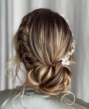 Romantic crown braided bun with side braid and soft face-framing tendrils