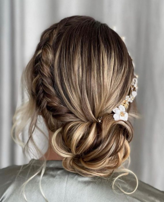 Romantic crown braided bun with side braid and soft face-framing tendrils