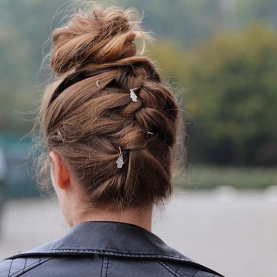Upside down braided bun hairstyle with sleek braid and messy bun