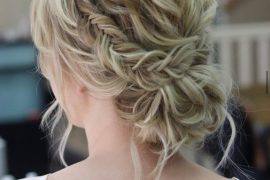 Small fishtail braided messy bun with textured waves – romantic bridal hairstyle