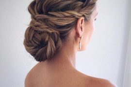 Polished twist braid wrapped bun bridal hairstyle with low sleek bun