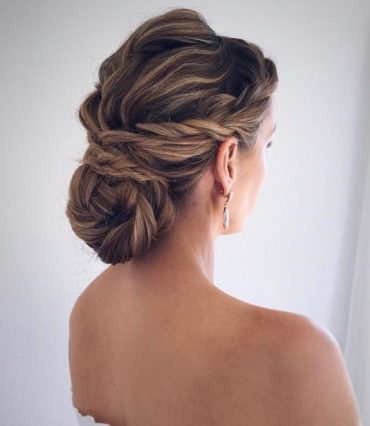 Polished twist braid wrapped bun bridal hairstyle with low sleek bun