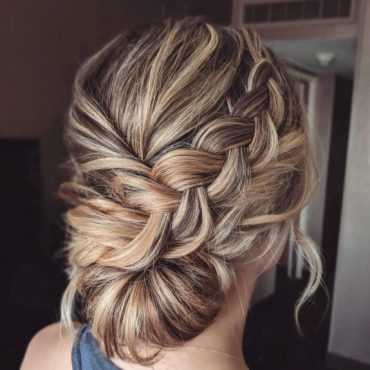 Dirty blonde braided updo with twisted low bun and soft braid detail – bridal hairstyle