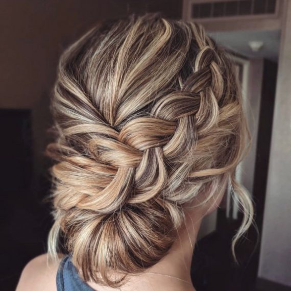 Dirty blonde braided updo with twisted low bun and soft braid detail – bridal hairstyle