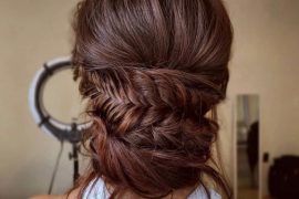 Cascading fishtail braided bun with romantic twists – perfect bridal hairstyle