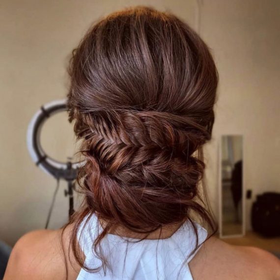 Cascading fishtail braided bun with romantic twists – perfect bridal hairstyle