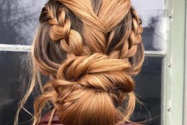 Bold edgy braided low bun hairstyle with twist details and volume for brides