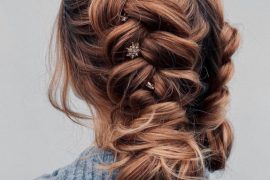 Braided bun with star hairpins and soft waves – romantic updo with celestial details