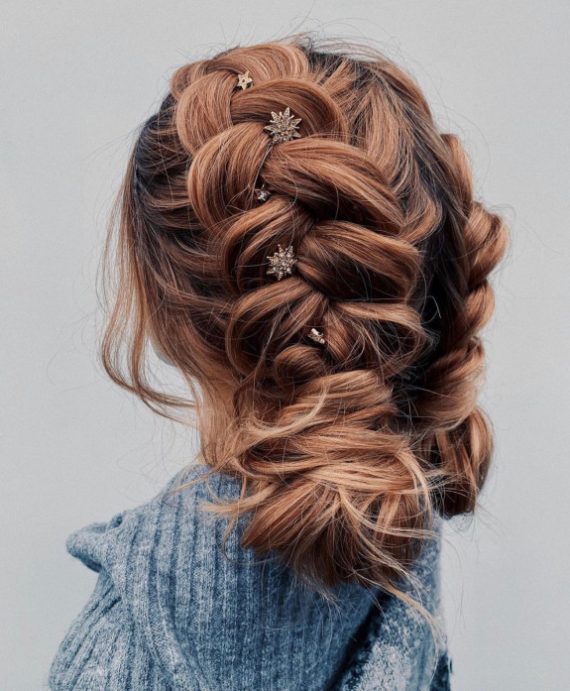 Braided bun with star hairpins and soft waves – romantic updo with celestial details