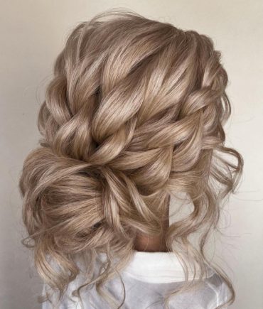 french-braided bun chignon, braided bun with weaves, braided ballerina bun, braided bun with bangs, easy braid bun hairstyles, cute braided bun hairstyles, braids with a bun on top, braided bun hairstyles for black hair, wedding hairstyle, bridal braided bun, wedding braided bun hairstyle. Voluminous braided messy bun hairstyle with soft tendrils – perfect for romantic summer brides