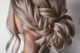 Romantic messy braided bun with textured low bun and soft braid