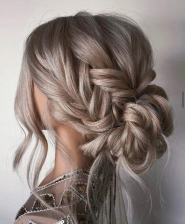 Romantic messy braided bun with textured low bun and soft braid