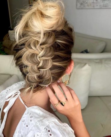 fUpside down braided bun with voluminous top knot and wide braid for bridal hair
