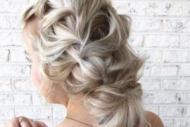 Blonde braided bun hairstyle with elegant crown braid and soft finish