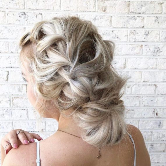 Blonde braided bun hairstyle with elegant crown braid and soft finish