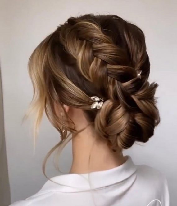 french-braided bun chignon, braided bun with weaves, braided ballerina bun, braided bun with bangs, easy braid bun hairstyles, cute braided bun hairstyles, braids with a bun on top, braided bun hairstyles for black hair, wedding hairstyle, bridal braided bun, wedding braided bun hairstyle. Braided bun hairstyle for brunette bride with soft tendrils and elegant hair clip