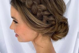 Modern bridal bun with chunky braid and low voluminous bun – romantic textured wedding hairstyle