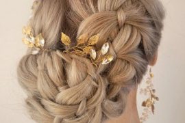 Elegant dutch braid bun bridal hairstyle with floral gold hairpins