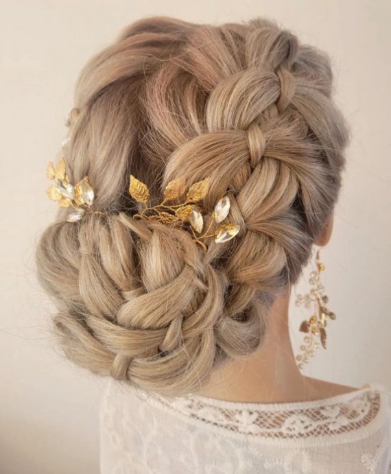 Elegant dutch braid bun bridal hairstyle with floral gold hairpins