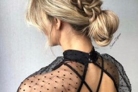 Soft romantic braided bun hairstyle with low bun and side braid for weddings