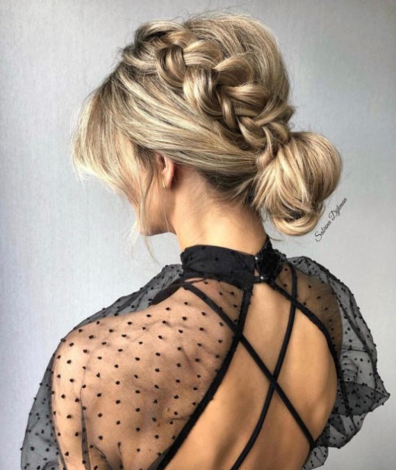 Soft romantic braided bun hairstyle with low bun and side braid for weddings