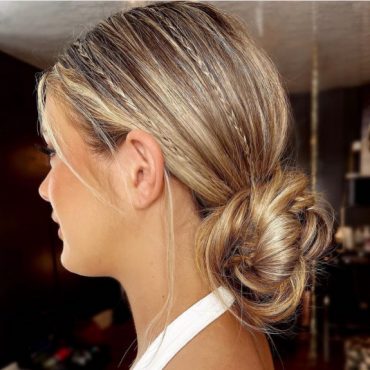 Micro braided bun hairstyle with sleek finish and low twisted bun – elegant bridal look