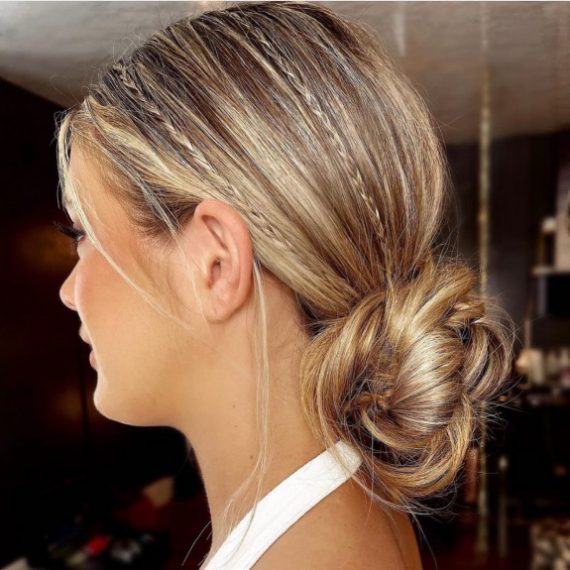 Micro braided bun hairstyle with sleek finish and low twisted bun – elegant bridal look
