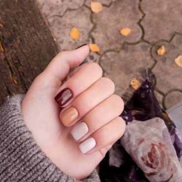 radient berry tone nails, fall nail designs 2022, burgundy nails, simple fall nail designs, fall nail designs short, mix and match fall designs, different color fall nails, fall 2022 nail trends, brown nails, french tip nails fallGradient short nails in brown, caramel, taupe, and ivory tones, perfect for cozy autumn days.