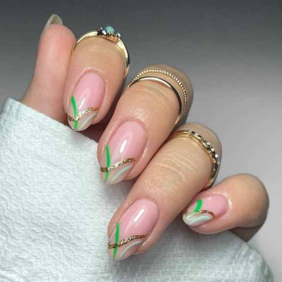 40 Nail Designs For Fall 2022 — Glitter and Green Swirl Tip Sheer Nails