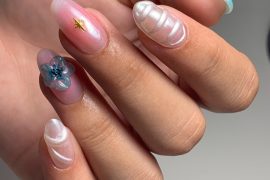 Almond-shaped nails with 3D pearl waves, glass flower, and translucent pink gel finish
