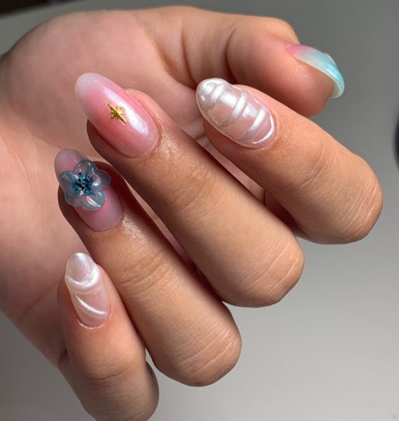 Almond-shaped nails with 3D pearl waves, glass flower, and translucent pink gel finish
