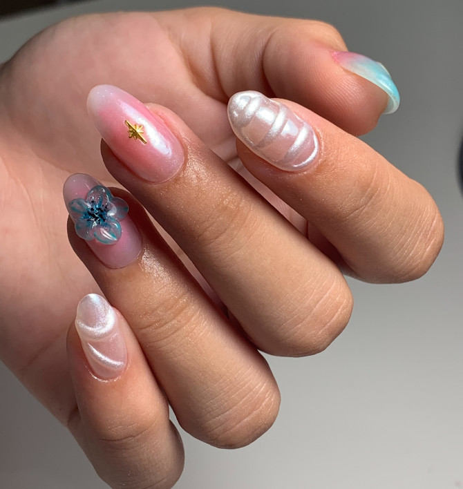 Almond-shaped nails with 3D pearl waves, glass flower, and translucent pink gel finish