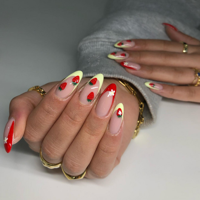 Almond-shaped nails with 3D cherry charms, strawberries, and daisy accents on nude base
