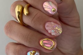 Short round nails with iridescent shell design, gold accents, pearls, pastel swirls, and abstract mermaidcore elements