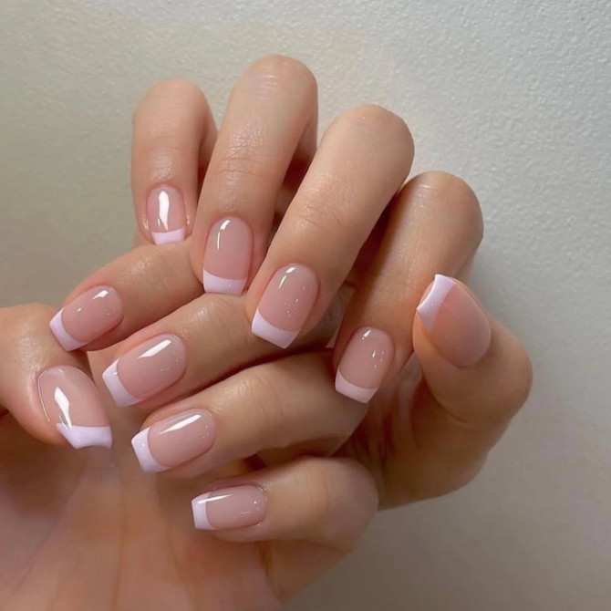 Short square-shaped nails with a nude pink base and glossy baby pink French tips