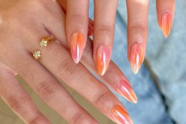 Almond-shaped nails with peach chrome finish and blended gradient in coral, blush, and white tones