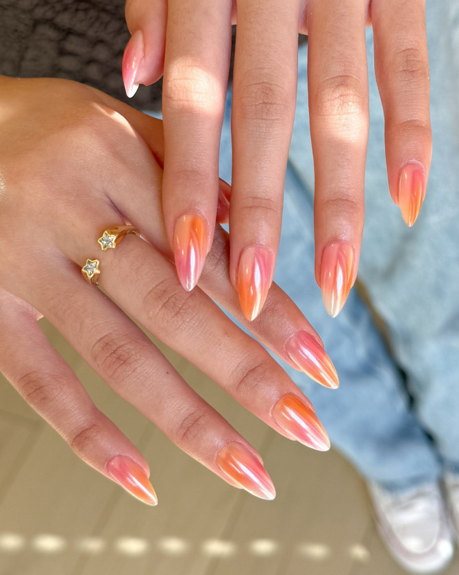 Almond-shaped nails with peach chrome finish and blended gradient in coral, blush, and white tones