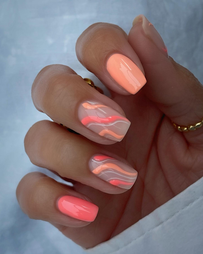 Short square nails with peach, coral, and pink swirl designs on nude base