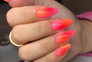 Neon pink to orange ombré stiletto nails with glossy finish