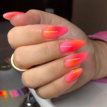 Neon pink to orange ombré stiletto nails with glossy finish