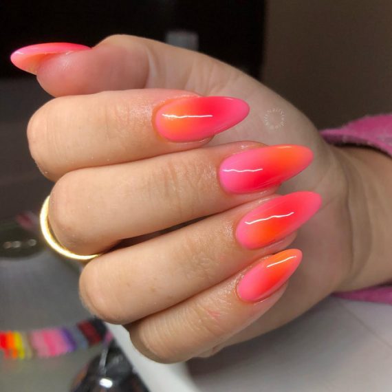 Neon pink to orange ombré stiletto nails with glossy finish