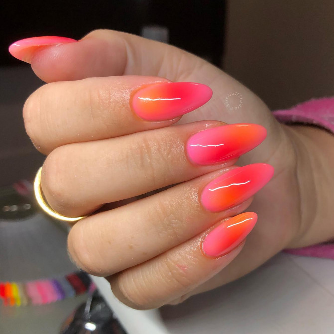 Neon pink to orange ombré stiletto nails with glossy finish 