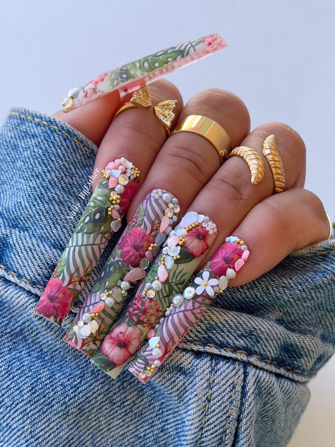 Extra-long coffin nails with tropical floral print, 3D hibiscus flowers, pearls, rhinestones, and leaf details