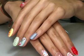 Oval nails with multicolor designs, 3D gel swirls, dots, and abstract textures on each fingertip
