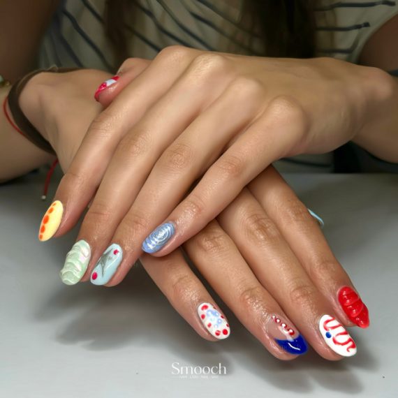 Oval nails with multicolor designs, 3D gel swirls, dots, and abstract textures on each fingertip