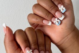 Square French tip nails with baby blue accents and 3D white bow charms