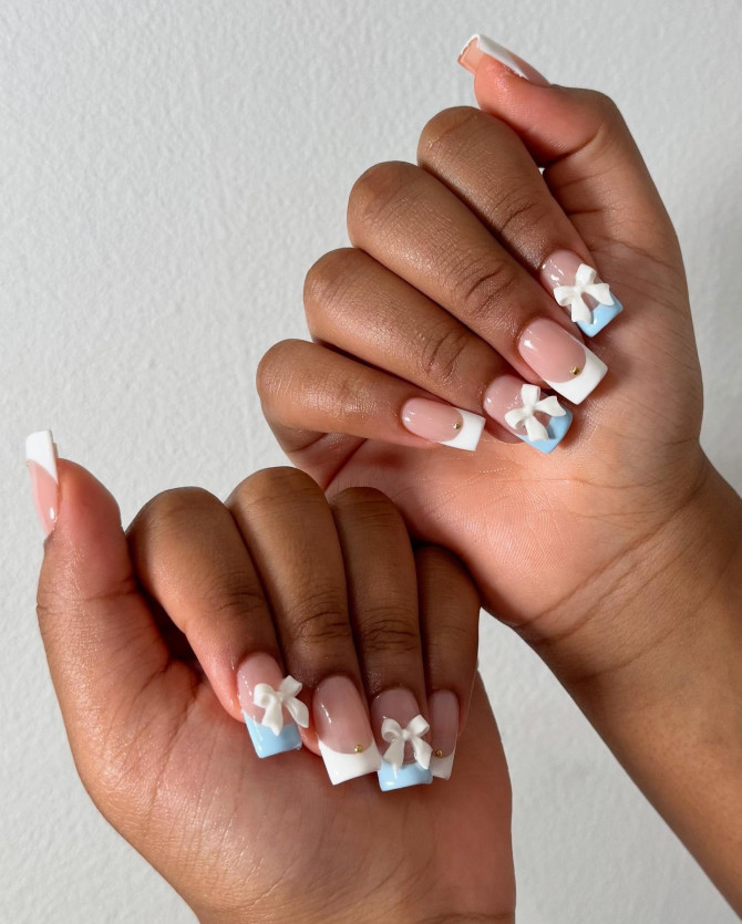 Square French tip nails with baby blue accents and 3D white bow charms