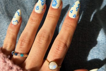 Blue Doodle on White Almond Nails for a Youthful Twist